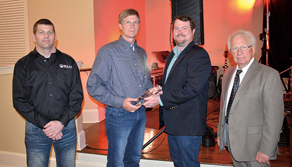 From left, Rusty and Brett McLain with McLain Farms receive the Grower of the Year award from Lee Lancaster with the Georgia Department of Agriculture and Bob Stafford, manager of the Vidalia Onion Committee.