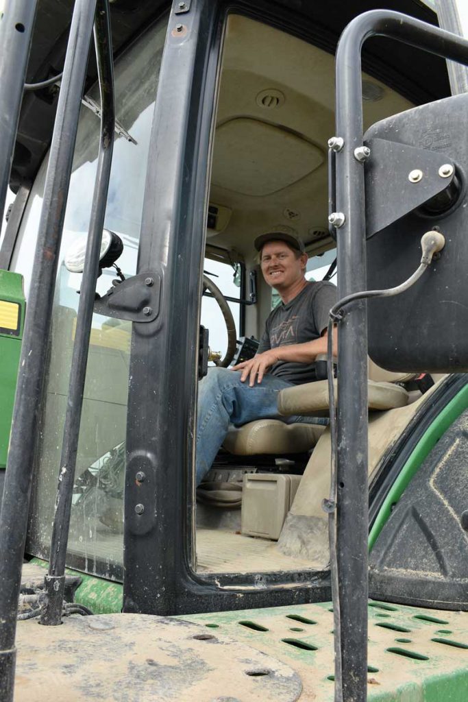 Russel Frisby drives a harvester during harvest.