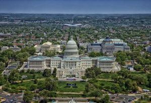 US Capitol building flanked by the Library of Congress and the Supreme Court