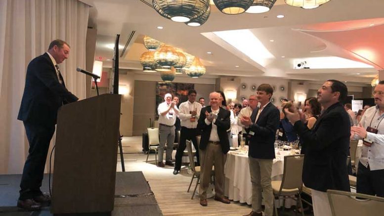 Doug Stanley, the outgoing NOA president, receives a standing ovation at the NOA convention banquet.