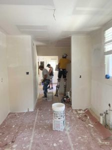 The building was formerly a restaurant, so an extensive remodel was undertaken to create offices. Here, a crew installs drywall.