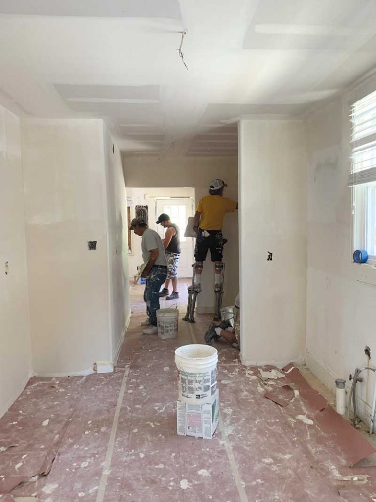 The building was formerly a restaurant, so an extensive remodel was undertaken to create offices. Here, a crew installs drywall.