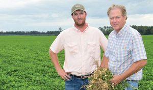 Parker Heard (left) will one day take over the family farm in Brinson, Georgia, from his father, Glenn Heard (right).