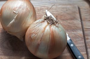 onions and knife on a cutting board