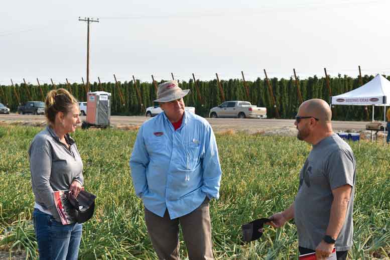 George Crookham (center) visits with customers.