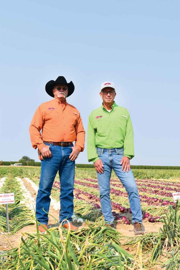 Crookham sales reps Rob Gobleck (left) and Lyndon Johnson attend the Crookham Summer Onion Reveal in Wilder, Idaho.