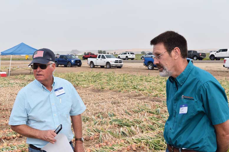 Kerrick Bauman (left) visits with OSU’s Stuart Reitz at the Malheur Experiment Station.