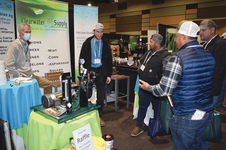 Bob Mittlestadt and Jacob Harder with Clearwater Supply talk with trade show attendees. 