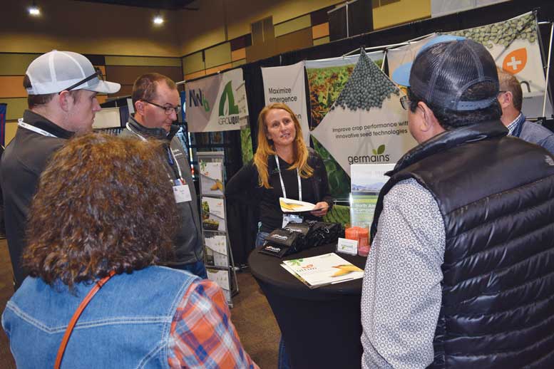 Stacy Davis with Germains Seed Technology discusses the company’s offerings with trade show visitors.