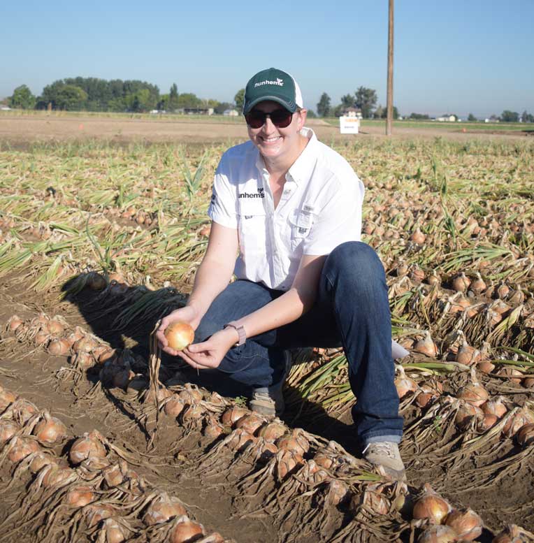 Kaitlyn O'Neal, BASF Nunhems onion regional crop lead for the Americas, shows off the tearless Sunions variety grown in Parma, Idaho.